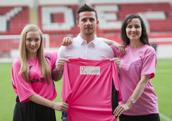 IN THE PINK: Clydes new player/coach Barry Ferguson is pictured at the launch of the new strip with Molly Gracey (left) and Glasgow University development officer Catherine McGrory.