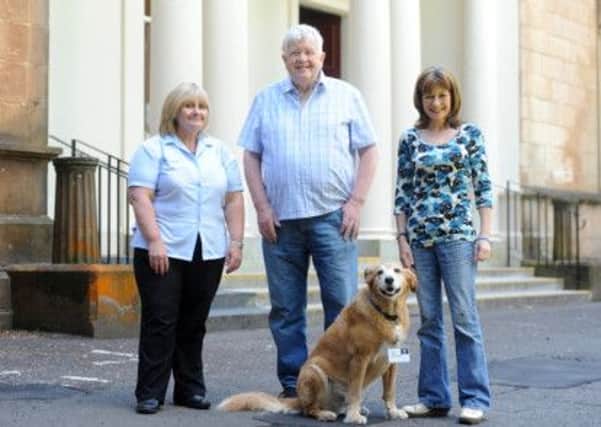 Lindsay McLean with her dog Murphy and centre staff Eleanor Ferguson and Bobby McLachlan.