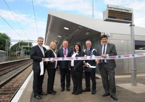OPENING DAY: MSP Jamie Hepburn cuts the ribbon to open the refurbished Cumbernauld station watched by (from left) George Allan, stations manager; Margaret Hoey, station team manager; Alex Sharkey, Network Rail area director; Natasha Ferguson, management apprentice; and Raymond McLaren,  station customer service.