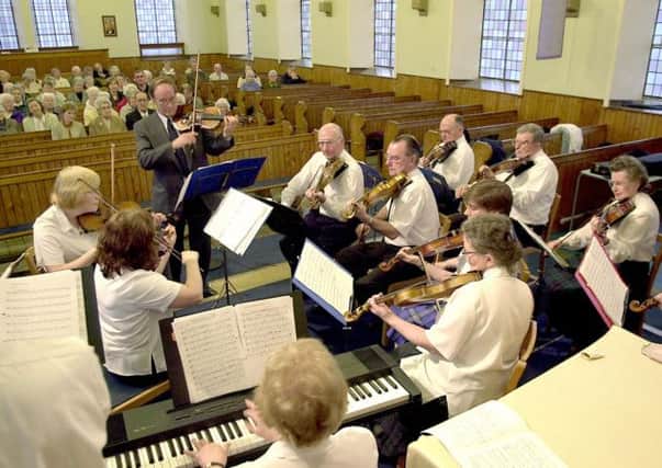 SOUND OF THE STRINGS: There was music in the air when a Fiddlers Rally was held in Kilsyth Methodist Church in 2002. (Picture by Alan Murray, ref. 4320)
