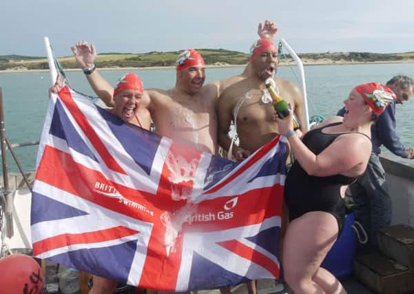 Celebrations...Gemma Gibb (right) and swimming relay team-mates open the bubbly in France