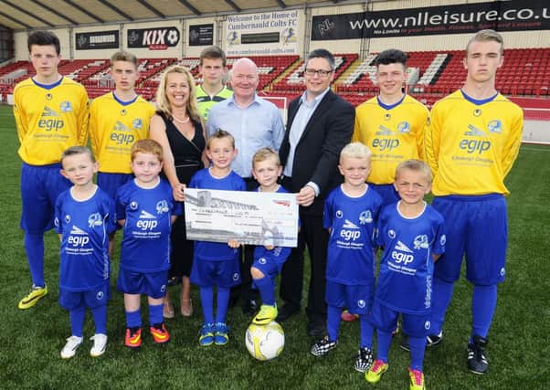COLTS CASH: Some of the club's players are pictured with (from left) Susan Menzies of Sportsmatch, Stewart Mackenzie, and Network Rail's Scott Smith.