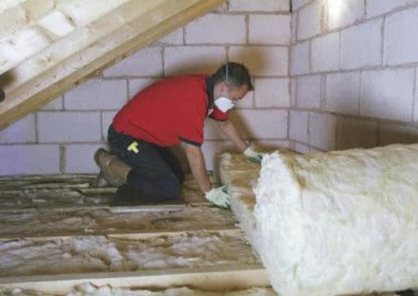 Loft insulation being installed. Photo: PA Photo