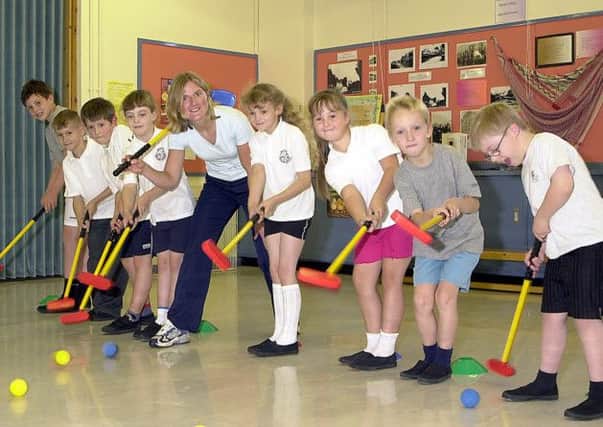 TEEING OFFf: Youngsters of primaries four and five at Banton Primary School were treated to some golf tuition in 2002. (Picture by Alan Murray, ref. 4687)