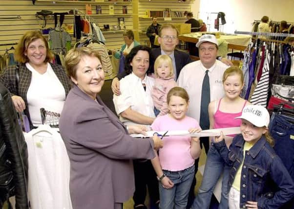 CHARITY OPENING: Cathie Craigie, MSP, cuts the ribbon to officially open Cumbernauld town centres new Child Aid charity shop in 2002. (Picture by Alan Murray, ref. 4695)