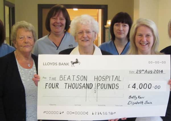 Cheque please...Betty Kerr and daughter Elizabeth hand over cheque to staff at the Beatson Cancer Centre