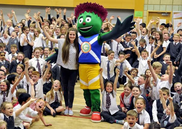 11-06-2014. Picture Michael Gillen. CUMBERNAULD. Cumbernauld Primary School. Commonwealth Games, Glasgow2014 mascot, Clyde makes his last visit to a school before the start of the games. Beth Gilmour 14 (ex pupil) designed him. Beth is now a pupil at Lenzie Academy. Beth and Clyde are pictured together at the school.