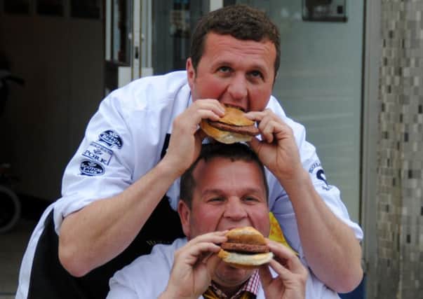 Taking a bite...Hugh and Craig tuck into award winning sausage