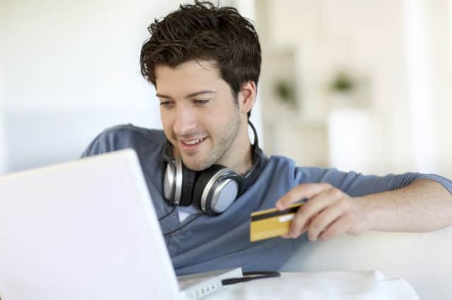 A student shopping online using his credit card.
