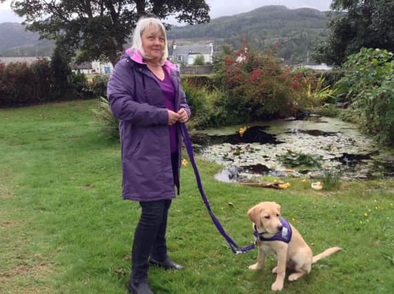 Volunteer Val, from Giffnock, with an assistance dog in training