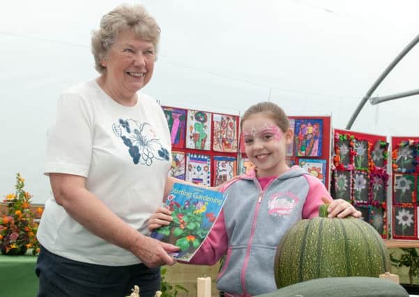 Growing gardeners...Sylvia Russell cultivates a new generation of green-fingered volunteers at the first ever Castlebank Park Harvest Festival (Pics by Katherine Sutherland)