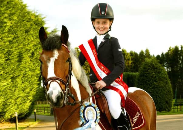 Riding high...Eight-year-old Lauren Forrest has won two showjumping titles (Pic by James Clare)