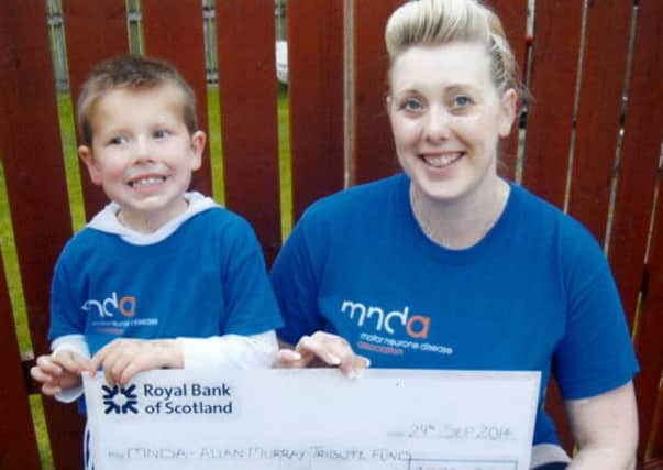Back to earth...Laura and son Blair with the charity cheque