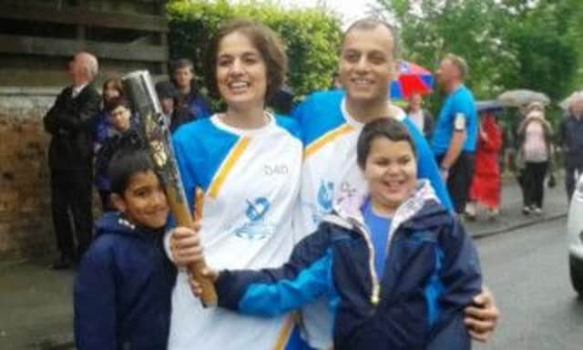 Ayesha and family pose for pictures after mum Noreen carried the Queens Baton through Newton Mearns