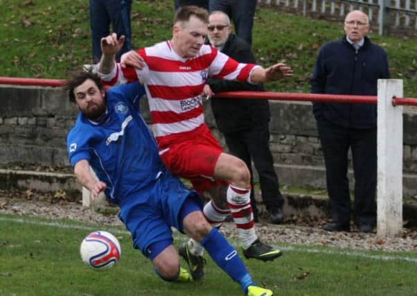 Tough tackling...at Saturday's local derby (Pic by Johnny Weir)