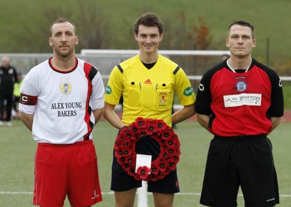 Remembering the fallen...Carluke Rovers and Wishaw players on Saturday (pic by Kevin Ramage)