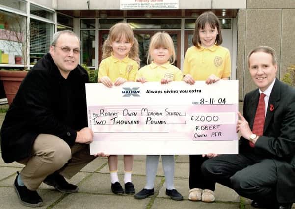 Cheque out...Robert Owen PS head teacher David Lynas given £2000 cheque from newly-formed PTA.