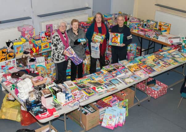 Team effort...Mary McLellan and other members of the New Beginnings team with some of the toys donated