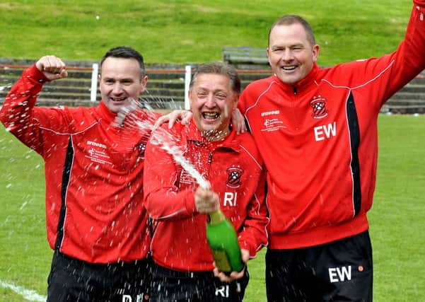 Champagne days...Robert and 'Gow backroom staff celebrate promotion two years ago (Pic by Lindsay Addison)