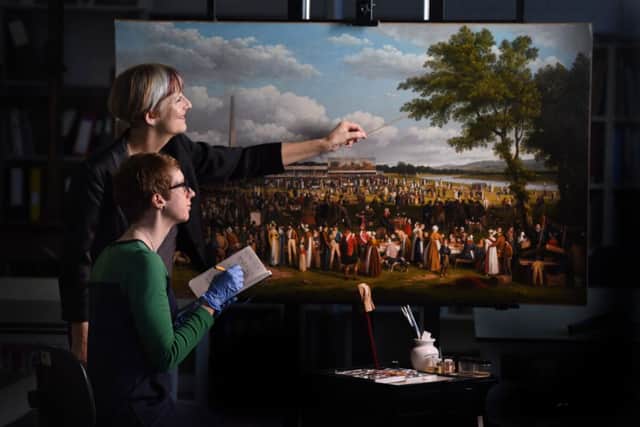 Conservator Polly Smith and curator Dr Jo Meacockthe view painting. Photo by Ian Watson.