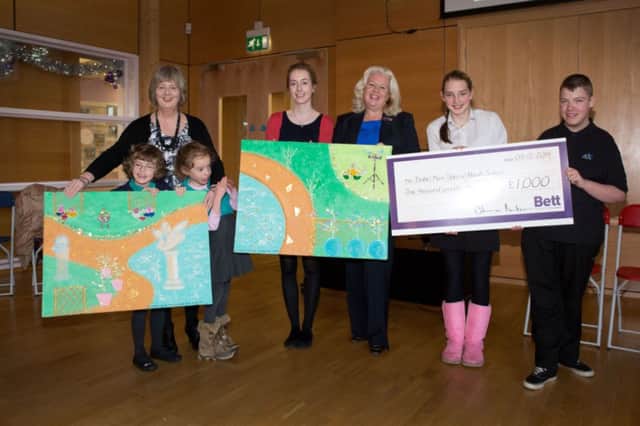 Bett Homes has donated £1,000 to equip the school with Android tablets for the children.  To say thank you, the children have created two garden scene canvases, which they will be presenting to Bett Homes Sandra Lockhart and Alison Maternaghan at their assembly on December 5th 2014.

(l-r) Head of School Mari Wallace with Kate and Holly,  Alison Maternaghan and Sandra Lockhart,   Rachel and  Anthony. 

Credit Marc Turner / PFM Pictures