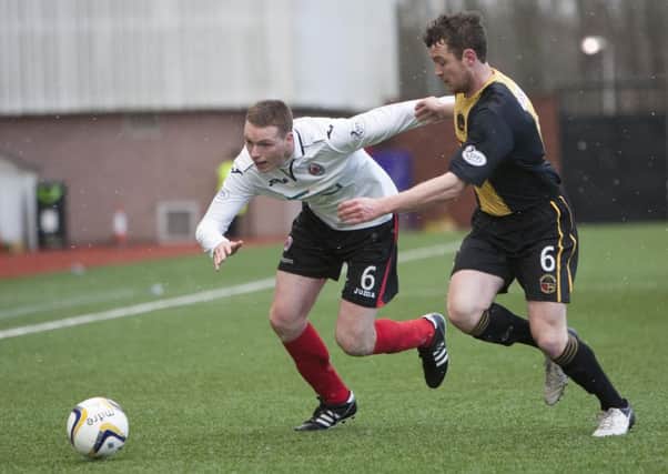 GETTING AWAY: Clyde's Brian McQueen shrugs off the challenge of a Berwick player during Saturday's game at Broadwood.