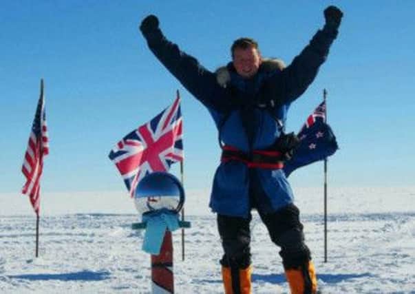 Arms aloft...Newall Hunter celebrates his arrival at the South Pole, after a solo ski which included the terror of seeing a crevasse open under his skis