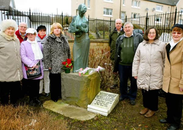 Memorial...tributes are laid at the statue which once stood outside the William Smellie Maternity, after a visit to the cemetery. (Pic Jim Clare)