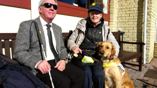 Sandy Taylor, chairman, Margaret Hutchison, vice chairman, and Bob the assistance dog