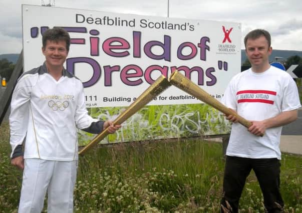 Deafblind Olympic volunteers with the Olympic torch