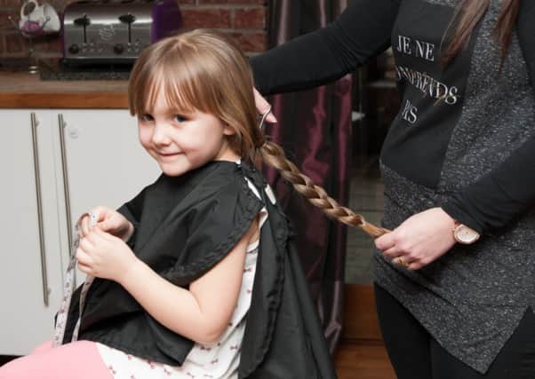 One snip...and Charley's plaited hair can help a child undergoing cancer treatment (Pic Sarah Peters)