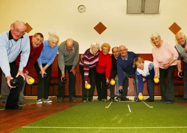 Ravenstruther and Cleghorn Over-60s Club members pictured during a break in play at Ravenstruther Village Hall. Club president Ian Alexander has told the Gazette that new members are needed to preseve the long term future of the club (Pic by Jim Clare)