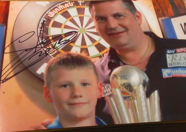11-year-old Carstairs lad Adrian Wilson beat PDC world darts champion Gary Anderson in an exhibition at Holytown Community Centre in late April 2015 (Submitted pic)