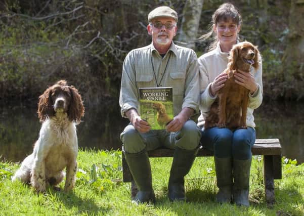 07-05-2015 Picture Sarah Peters. Graham Gibson, from Lamington Kennels, who has written a book on Gun Dog Training. His girlfirend Holly Donaldson pictured with him took all the photos for the book. Dogs are Spaniel Jamie and smaller cocker spaniel Willow.  These were the dogs that were photographed in the book.