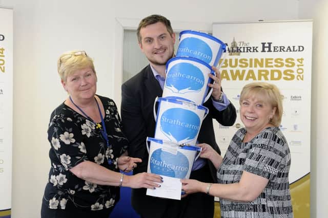 David Oliver hands over donation buckets from The Falkirk Herald Scottish Cup party at The Shed. Picture: Michael Gillen
