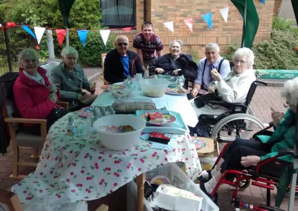 Residents and staff enjoy a big lunch at Eastwood Court care home