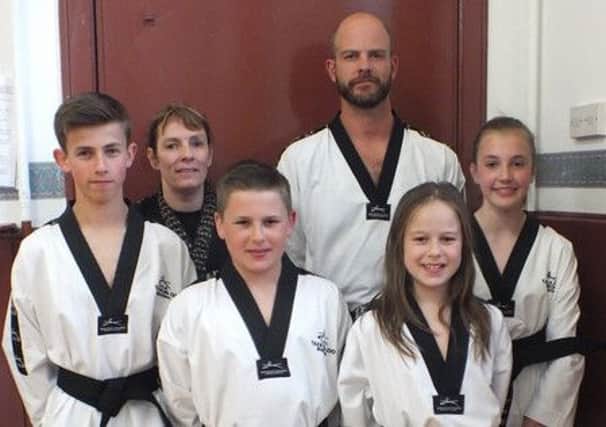 Belted...Biggar Taekwon-Do's first black belts Dylan Paterson, Robbie Leitch, Isla Aitken, Olivia Godfrey, and Lyle Godfrey (submitted picture)