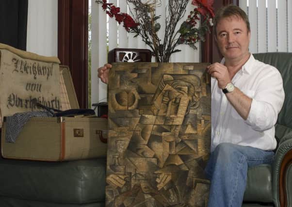 Dominic Currie pictured with the painting.