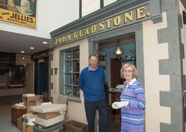 Unpacking...Biggar Museum Trust volunteers Mike Hunter and Ann Matheson at one of the shops from Gladstone Court recreated in the new museum (Pit by Sarah Peters)