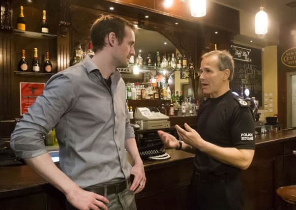 Chief Constable of Police Scotland Stephen House (right) talks to Butterfly and Pig employee Paul Banham during the launch of a the latest phase of rape prevention campaign at the Butterfly and Pig bar in Glasgow. PRESS ASSOCIATION Photo. Picture date: Wednesday July 8, 2015. The campaign is aimed at 16 to 27-year-old men, the age group most likely to commit rape and sexual offences, and will feature a hard-hitting TV, cinema and digital advert. Photo credit should read: Danny Lawson/PA Wire