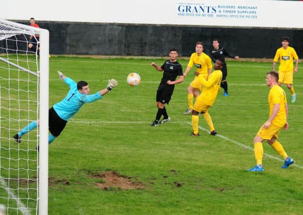 Action from BSC Glasgow v Cumbernauld Colts. Stephen O'Neill watches as his shot crashes off a post