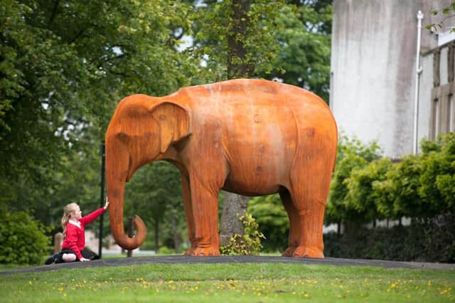 04/09/15 . GLASGOW. Young Sarah McCoy 9 from Craigton Primary Schoolgets up close tp the sculpture.
Venue: House for an Art Lover, Bellahouston Park, 10 Dumbreck Road, 
The â¬Üunveilingâ¬" of a life size Asian Elephant by artist Kenny Hunter, 

Background
A life-size Asian elephant created by Scottish sculptor, Kenny Hunter, is unveiled on the site of 
the 1938 Empire Exhibition in Bellahouston Park on Glasgowâ¬"s south side.  A year in the making, the elephant was chosen as a direct connection to many Commonwealth countries in South Asia and 
Africa where Glasgow-built trains were deployed and where the elephant is seen as both a form of 
transport and an animal of symbolic power.  The 11 ton elephant has been cast using redundant and scrap locomotive parts which were made in the shipyards of nearby Govan.  The Elephant is a legacy icon for Glasgow 2014, celebrating the cityâ¬"s links within the Commonwealth.  House for an Art Lover were assisted in the project by local companies Weir Group and Malcolm.
