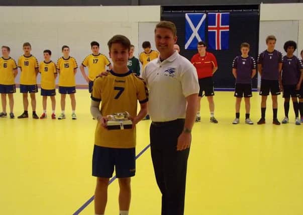 Craig Yule of Tryst '77 receives his Scottish Handball Association award