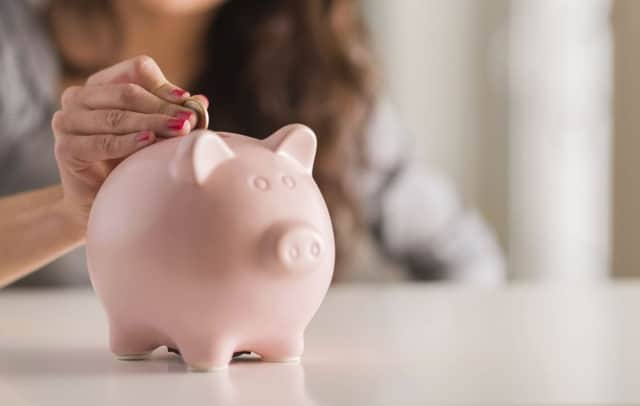 A woman putting money in a piggybank. See PA Feature FINANCE Household. Picture credit should read: PA Photo/thinkstockphotos. WARNING: This picture must only be used to accompany PA Feature FINANCE Household.