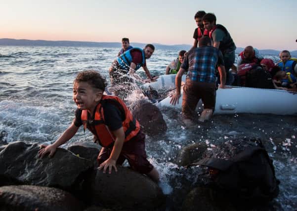 A group of Syrian refugees arrive on the island of Lesbos after traveling in an inflatable raft from Turkey, near Skala Sykaminias. Picture: UNHCR/Andrew McConnell