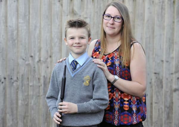 Picture 30/9/15 Emma Mitchell.
 Pic of Caelan Shinie (9) young pipe band boy with his chanter and his mum Laura who climbed Ben Lomond to raise cash for Kirky Pipe Band.