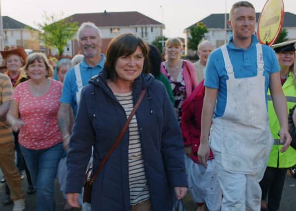 Actress Carole Cassidy (front) in the TV advert encouraging people aged over 50 to take a bowel cancer screening test.