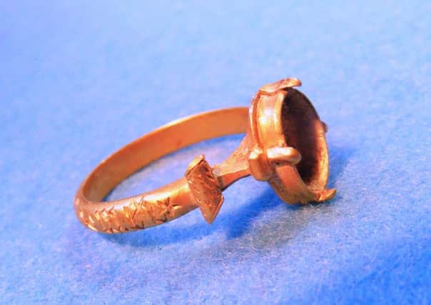 Treasure Trove annual report -  15th century Gold Finger Ring, Loch Leven, Perth & Kinross(TT.92/14)
A substantial gold finger ring with the bezel set for a stone, although this is now missing. The exterior of the hoop is engraved with the inscription mat m memeto mei, a contraction or variation on the common mater dei, memento mei, or Mother of God, remember me. The ring is undoubtedly a high quality piece that would represent a challenge to the medieval goldsmith and in both complexity and form this is an unusual survival in a Scottish context. Allocated to National Museums Scotland.