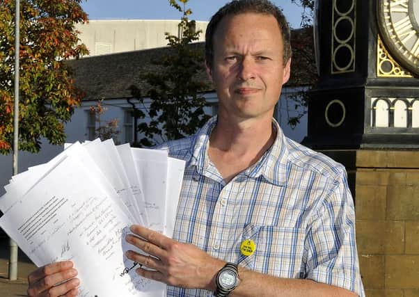 Gavin Templeton with petition for toilets.