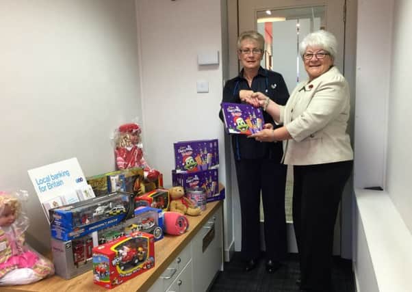 Mary M McLellan Convenor of New Beginnings Clydesdale receiving selection boxes and toys from TSB in Carluke for the 2015 Christmas appeal